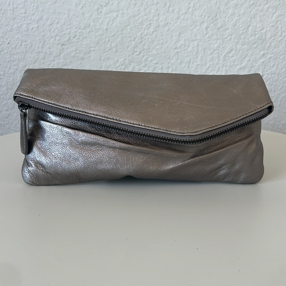 Gently used metallic asymmetrical envelope clutch.